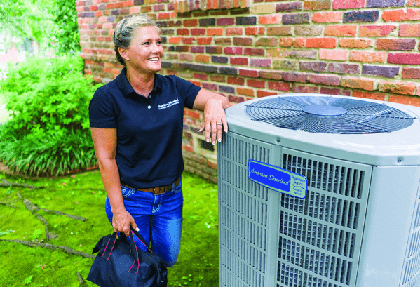 Tech performing American Standard AC tune-up